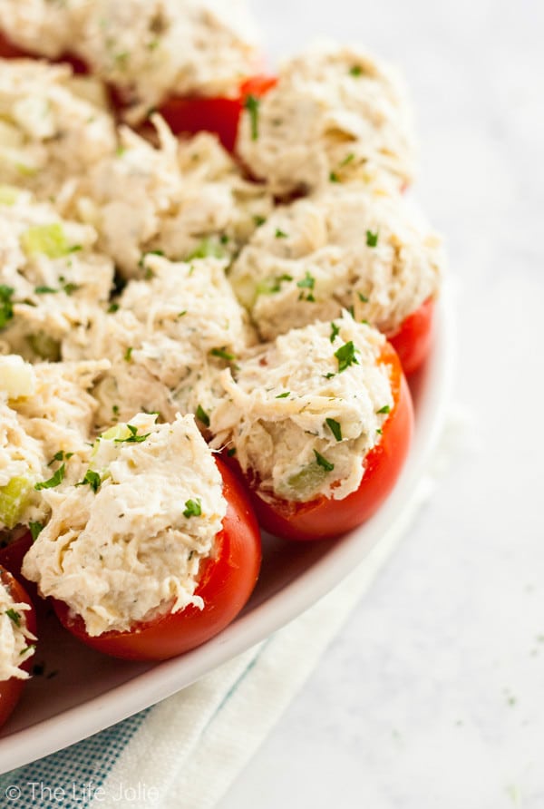Chicken Salad Stuffed Tomatoes are a simple, gluten-free twist on a chicken salad sandwich. They're made with Greek Yogurt and with apples and they're super easy to make ahead. They make a delicious healthy lunch or appetizer!