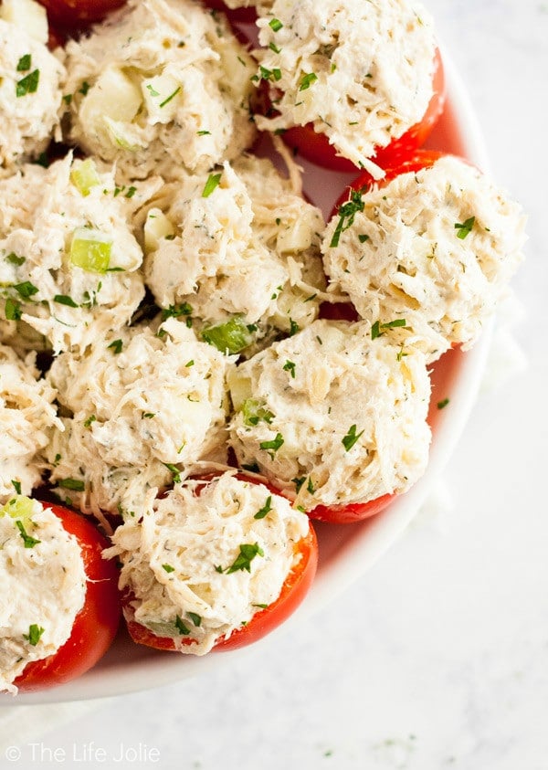 Chicken Salad Stuffed Tomatoes are a simple, gluten-free twist on a chicken salad sandwich. They're made with Greek Yogurt and with apples and they're super easy to make ahead. They make a delicious healthy lunch or appetizer!