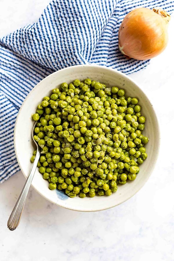Peas with Onions is the most easy side dish! With a few simple ingredients, this recipe is a snap to throw together on a busy week night but delicious enough to serve at a gathering or with a holiday dinner.