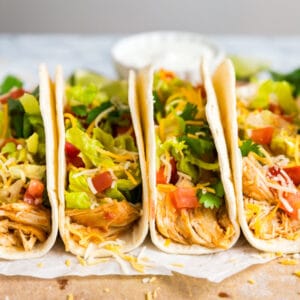 This Crockpot Chicken Tacos recipe is the easiest taco meat you'll ever make. With just 4 ingredients and minimal effort, your taco Tuesday will never be the same! Also includes Instant Pot instructions!