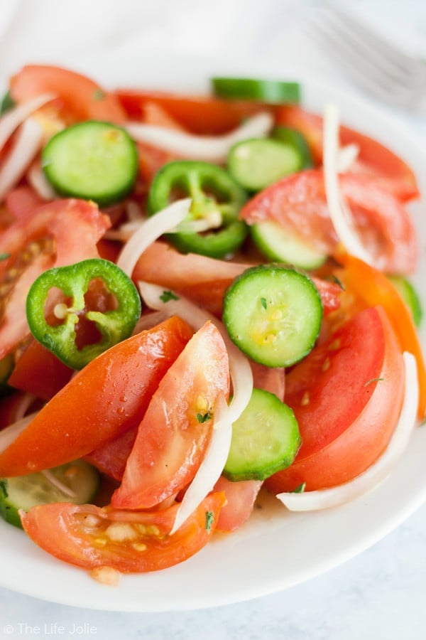 A close up of tomato salad on a plate 
