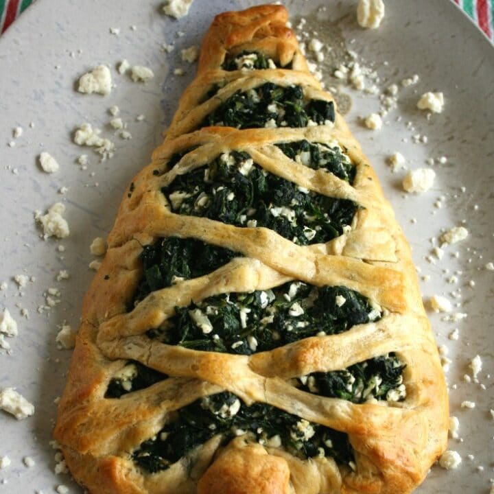 This Spinach and Feta stuffed bread is so easy to make and has the most delicious flavor. It makes a lovely holiday Christmas Tree appetizer or can be in the form of a regular stuffed bread any other time of year!