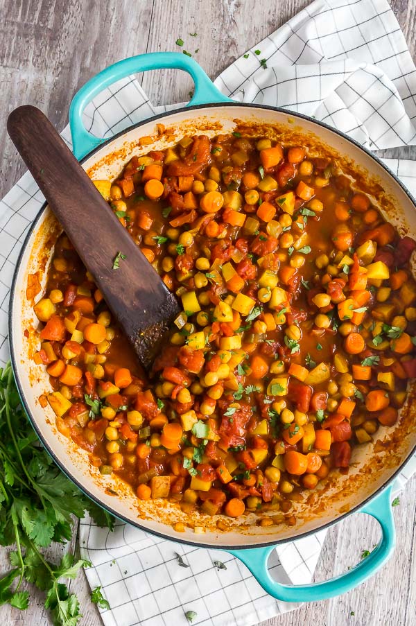 A overhead shot of Moroccan Chickpea Vegetarian Stew in a blue pan.