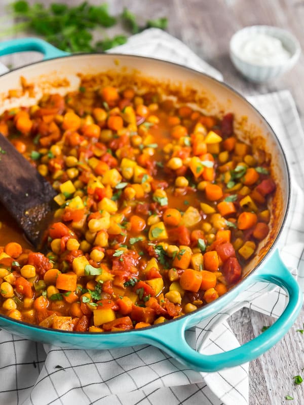 Moroccan Chickpea Vegetarian Stew In a blue pan with the left side of the image cut off.