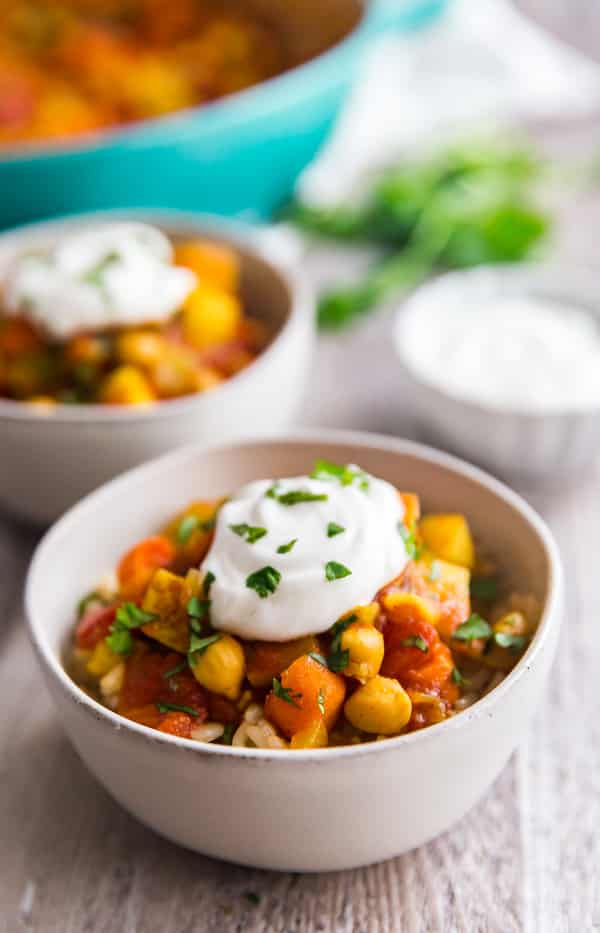 Moroccan Chickpea Vegetarian Stew with the pan and another bowl behind it.