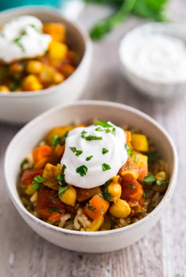 A bowl of Moroccan Chickpea Vegetarian Stew with greek yogurt and cilantro on top.