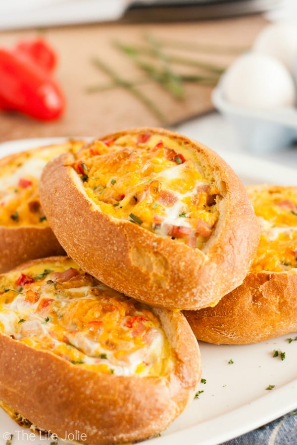 This Egg Stuffed Bread recipe is a delicious, easy brunch or breakfast option. Imagine crusty loaves of french bread, stuffed with your favorite omelette fillings, cheese and eggs. It's quick and delicious to serve during the holidays and is sure to be a family favorite!