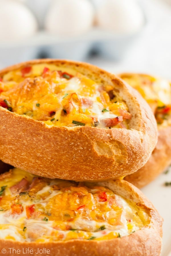 This Egg Stuffed Bread recipe is a delicious, easy brunch or breakfast option. Imagine crusty loaves of french bread, stuffed with your favorite omelette fillings, cheese and eggs. It's quick and delicious to serve during the holidays and is sure to be a family favorite!