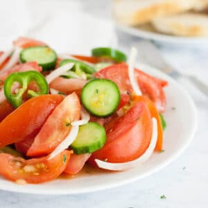 This cucumber tomato salad is perfectly versatile side for everything from casseroles to BBQ. Refreshing and delicious, this zesty (and slightly spicy) tomato salad is a bite of summer all year long.