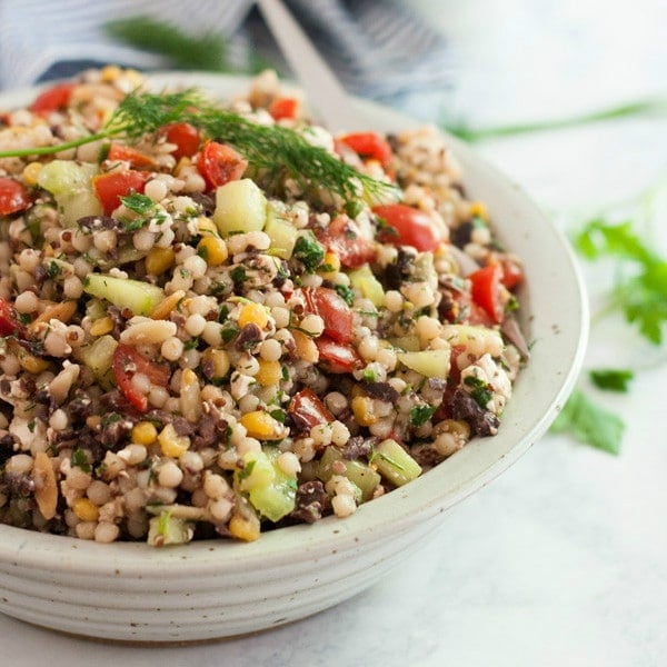 This Greek Couscous Salad recipe is a light and healthy side dish for lunch or dinner. It's quick and easy to make and is full of delicious flavors of Feta cheese, vegetables, olives and fresh herbs. Click on the photo to get the recipe!