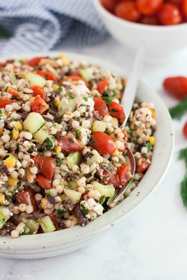 This Greek Couscous Salad recipe is a light and healthy side dish for lunch or dinner. It's quick and easy to make and is full of delicious flavors of Feta cheese, vegetables, olives and fresh herbs. Click on the photo to get the recipe!
