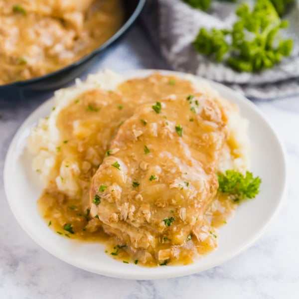 Say goodbye to dry and tough pork chops: these Smothered Crock Pot Pork Chops are the ultimate fall-apart tender comfort food. With just 4 ingredients, this easy dinner will be your new go-to dump dinner!