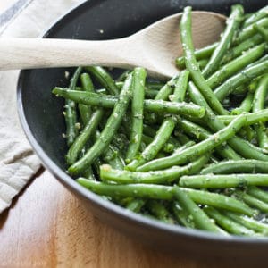Garlic Green Beans are a family favorite side dish recipe. They're super easy to make with a few simple ingredients like fresh green beans, garlic, butter and fresh parsley and are pretty quick to! Easy enough for weeknight dinner but special enough to serve for holiday dinners as well!