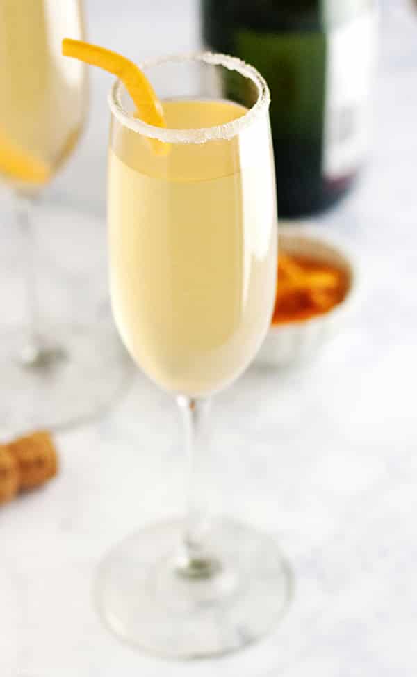 This Grapefruit Sparkler is a festive champagne cocktail! I love adult beverages featuring sparkling wine and this is simple to make and refreshing to drink at brunch or to ring in the New Year. This pretty drink will be a mainstay at your next girls night