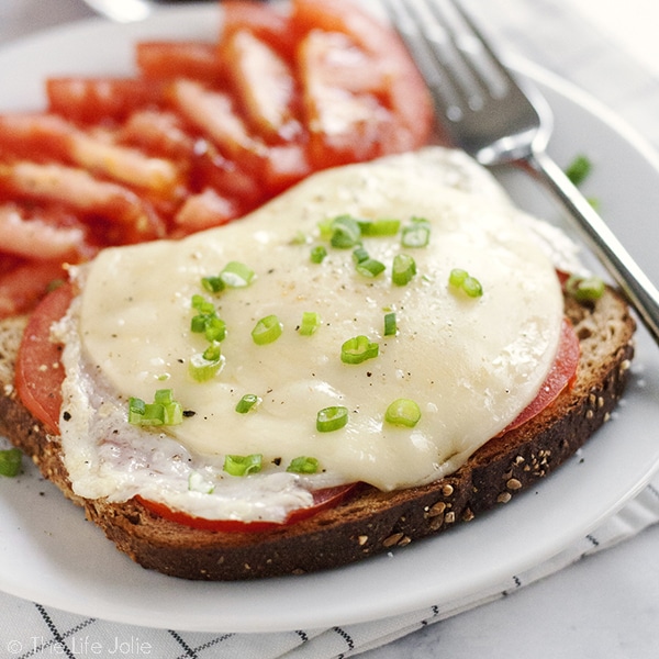 This Open-Faced Egg Sandwich is the best easy recipe option to throw together in the morning. Made with toast, fried eggs, cheese and tomatoes it's a healthy and delicious way to start the day!
