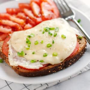 A close up of an open faced egg sandwich.