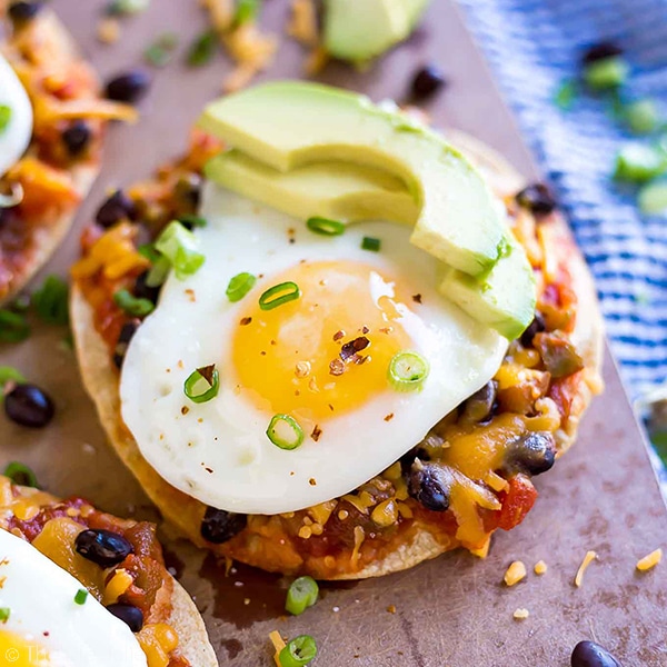 Baked Breakfast Tostadas are one of my favorite easy recipes to make for breakfast (or lunch- or brunch!). This is simple cooking at it's finest with corn tortillas, salsa, black beans, cheese and eggs. You can get creative and take it in whatever direction you'd like- this quick and delicious dish is definitely a keeper!