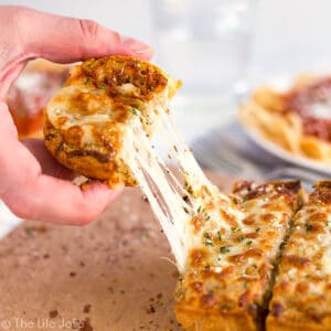 This homemade Three Cheese Garlic Bread recipe is a super easy accompaniment to a delicious Italian meal (or any meal for that matter!). It's really quick to spread with butter, herbs and a ton of melted cheese and pre-cut so that it's even easier to pull apart and enjoy with dinner! This is a major family favorite!