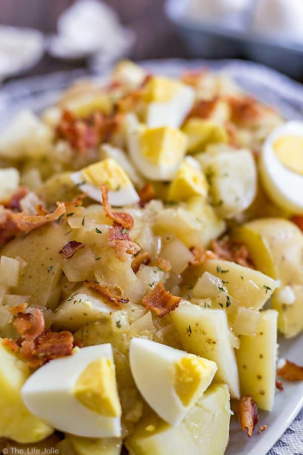A close up photo of the potatoes in German Potato Salad as well as bacon.