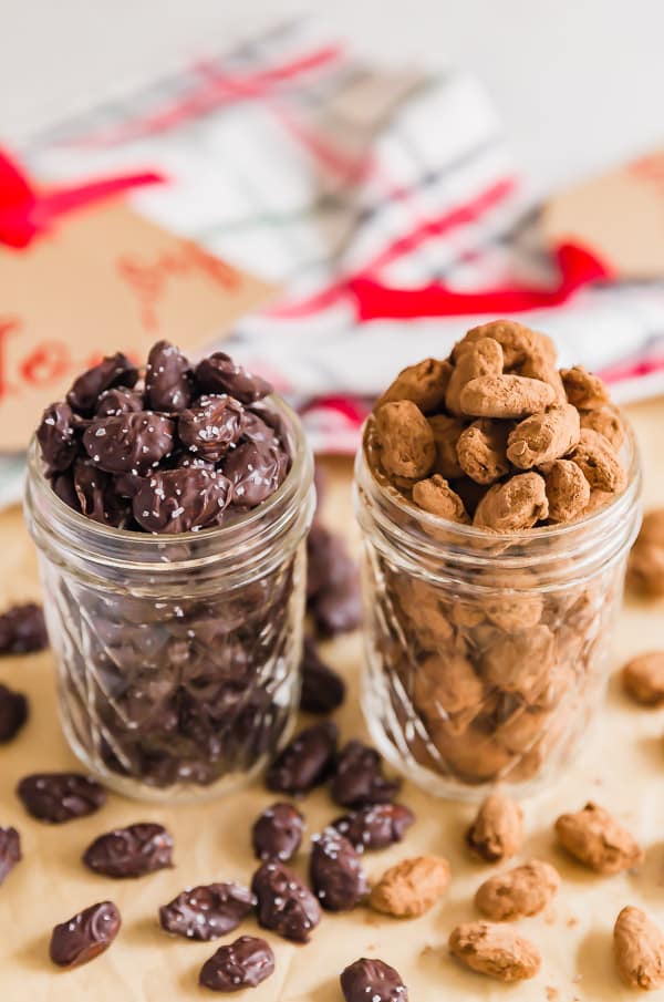 Jars of Chocolate Almond Candynext to each other with decorations in the background
