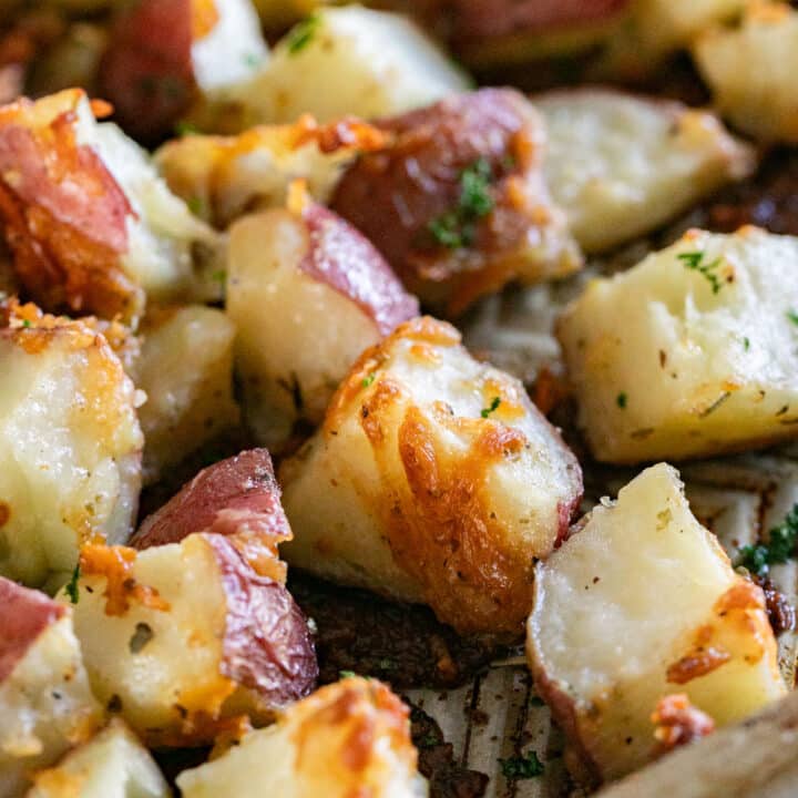 A close up image of roasted potatoes on a sheet pan.