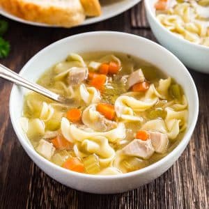 A square image of a bowl of Easy Homemade Chicken Noodle Soup.