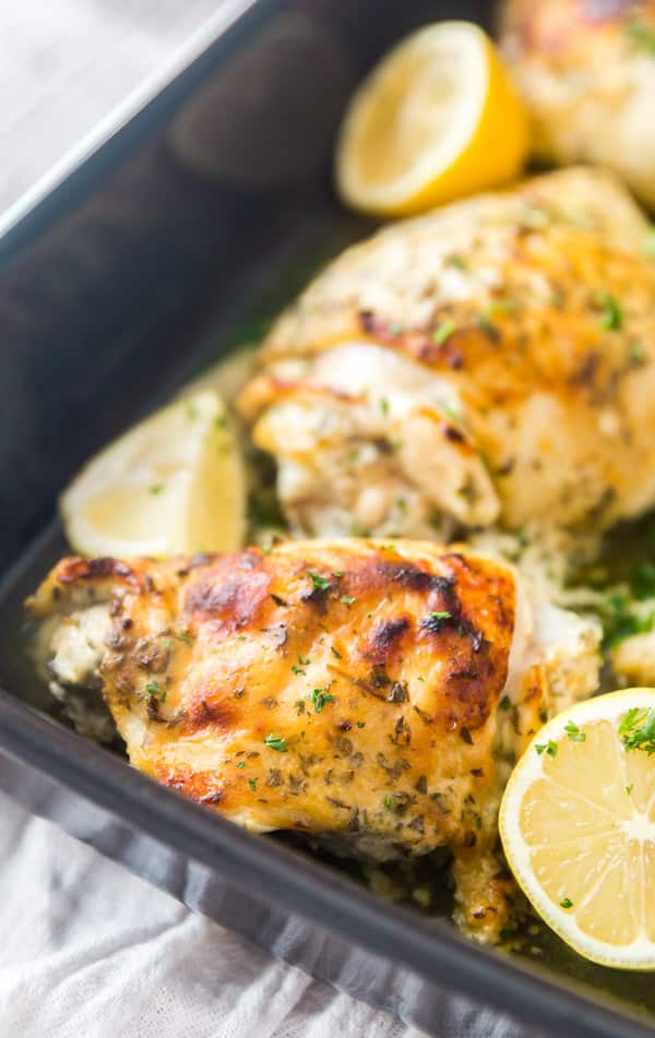 Perfectly browned Greek Yogurt Roasted Chicken Thighs in a gray pan.