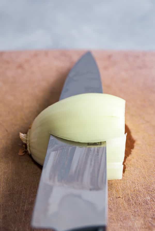A knife cutting into an onion.