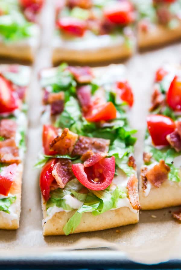 A close up of a slice of BLT Ranch Flatbread Pizza.