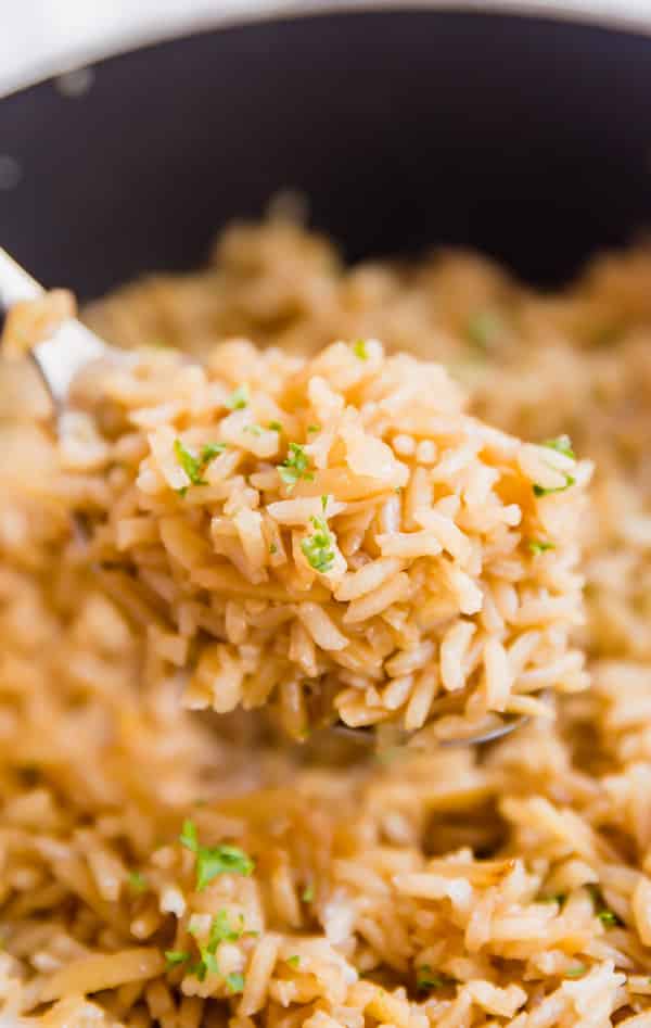 French Onion Rice Pilaf is full of savory flavor! It's a side dish that's as easy to make as it is delicious with only a little bit of work at the beginning an then you let your stove do it's thing so you can attend to the rest of your meal!