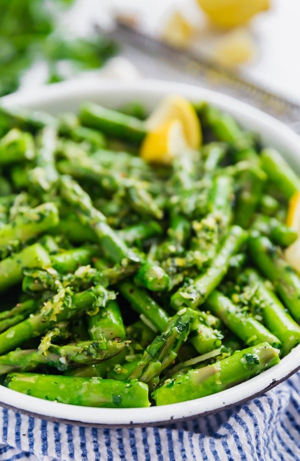 Sautéed Asparagus with Parmesan Gremolata is a light and fresh side dish that is as quick and easy as it is delicious! Tender asparagus with a mixture of garlic, lemon zest, parsley and olive oil make an excellent and refreshing vegetable side!