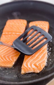 Salmon searing in a pan