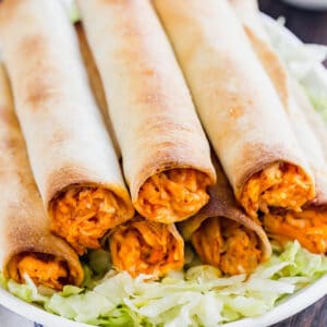 Meet your new favorite appetizer: Baked Buffalo Chicken Taquitos. Made with shredded chicken, buffalo sauce, ranch seasoning and mozzarella cheese, these are a quick and delicious way to become the most popular person at the party!