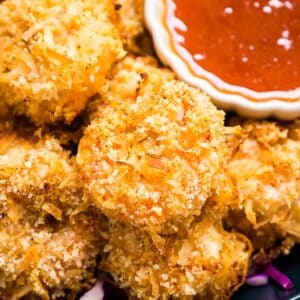 Meet your new favorite easy weeknight dinner: Baked Coconut Shrimp Recipe with Spicy Apricot Dipping Sauce. A little bit sweet. A little bit spicy. A whole lot of delicious.