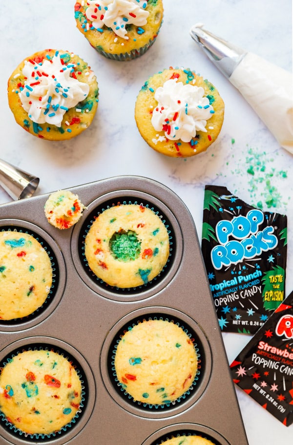 Firecracker Vanilla Cupcakes are the most fun kid's dessert the 4th of July- you'll love the POP ROCKS hidden inside for a totally fun surprise when you bite into them. These are a must-make and are SO easy!