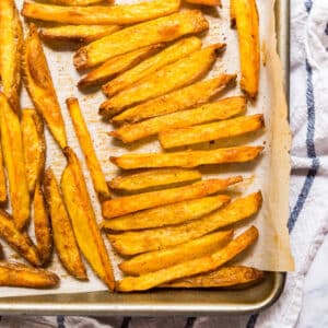 These Baked French Fries are perfectly crispy and crazy easy to make! Made with potatoes, oil and seasoning salt, these are a great weeknight side dish!