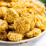 Oven Fried Pickles are the game day snack that dreams are made of! They're super easy to make with dill pickle chips, panic breadcrumbs, eggs and a BBQ Ranch dip, baked to be perfectly crispy and seriously easy to make!