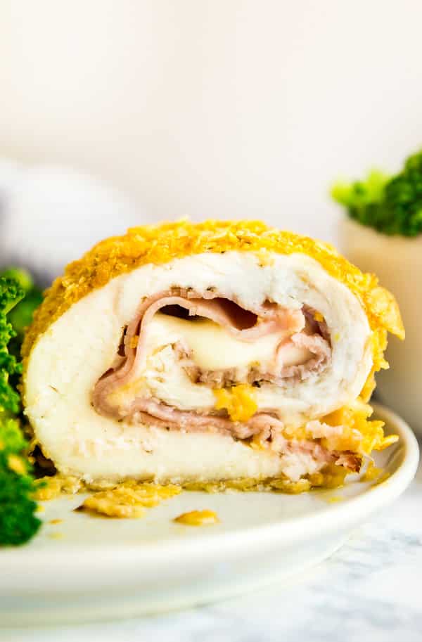 This Baked Chicken Cordon Bleu is easy to make and so delicious. Made with chicken, corn flakes, ham and Swiss cheese, it's a weeknight meal that will wow your family!