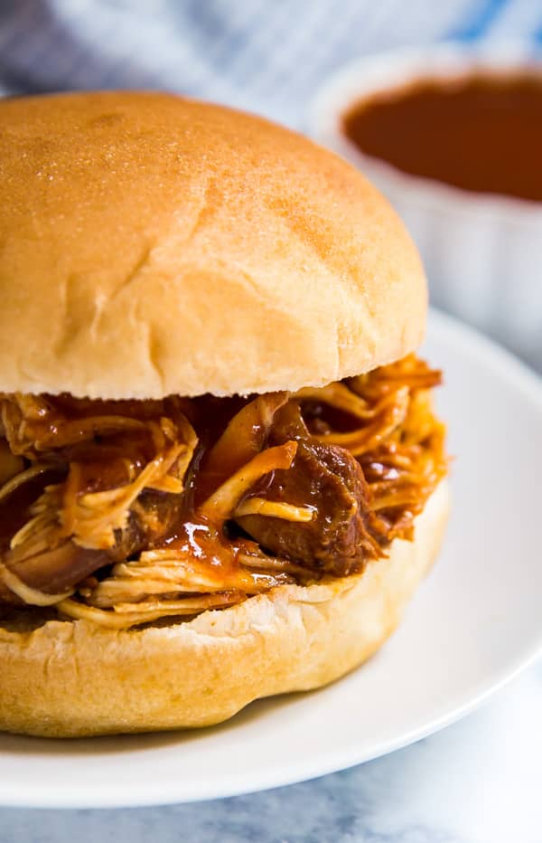 A close up of the side of a shredded BBQ chicken sandwich.