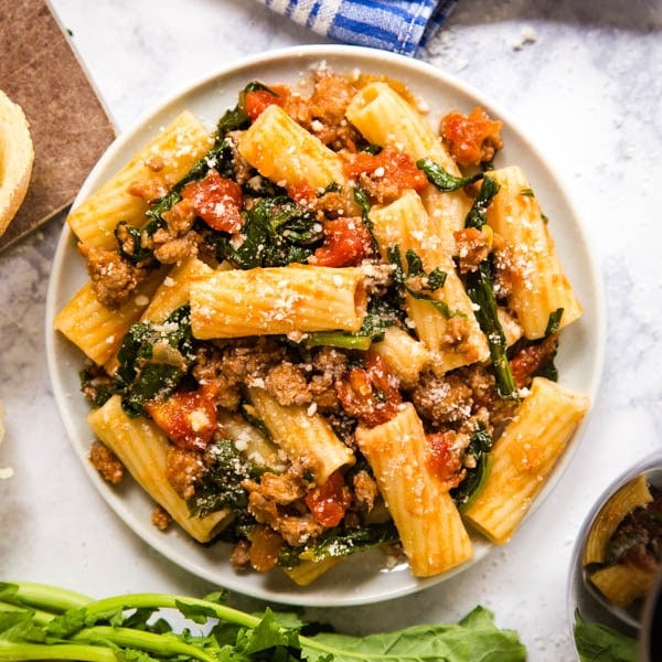 Spicy Sausage Pasta with Rapini is an easy and delicious dinner that will have everyone fighting for seconds! Made with rigatoni pasta, rapini, spicy Italian sausage and Tuttorosso San Marzano Style Chopped Tomatoes in Puree with Sea Salt, this is a definite keeper!