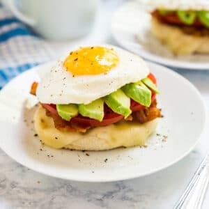 This California Breakfast Stack is a delicious way to start your day- it's light, fresh and seriously easy to make! This is made with English muffins, cheese, bacon, tomatoes, avocado and eggs. You've got to try it!