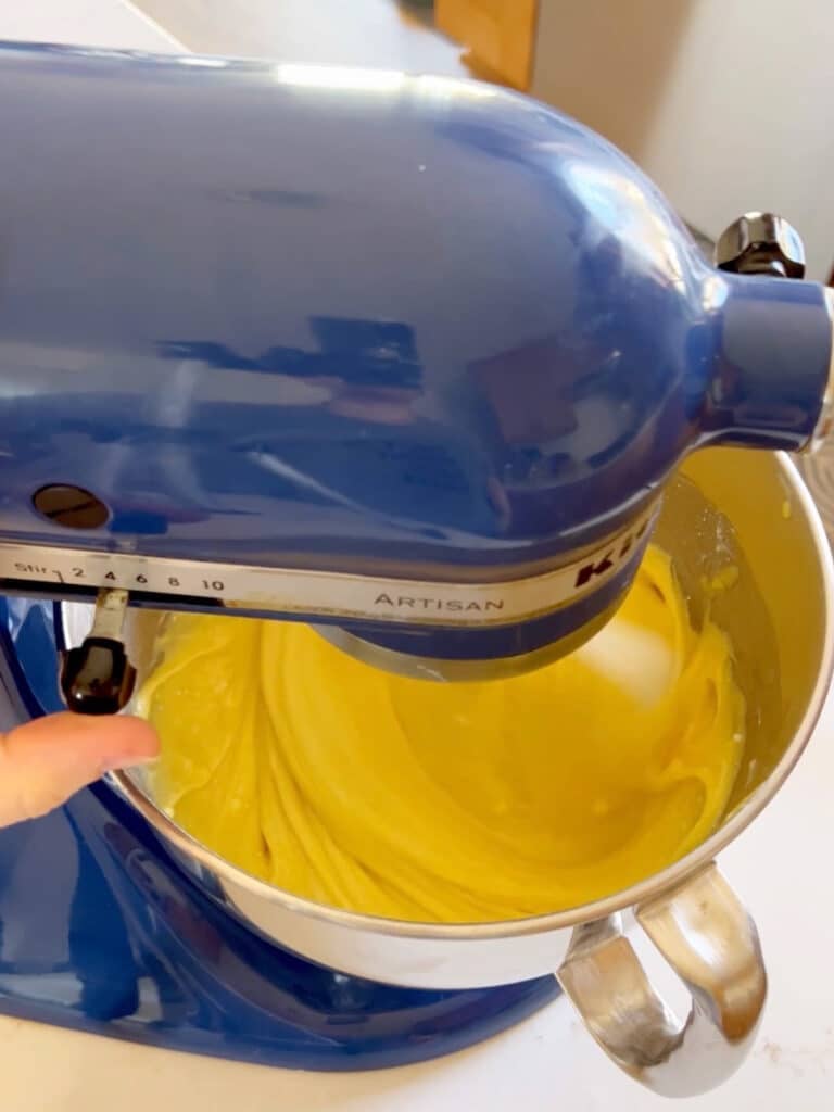 Cake batter being mixed in a stand mixer.