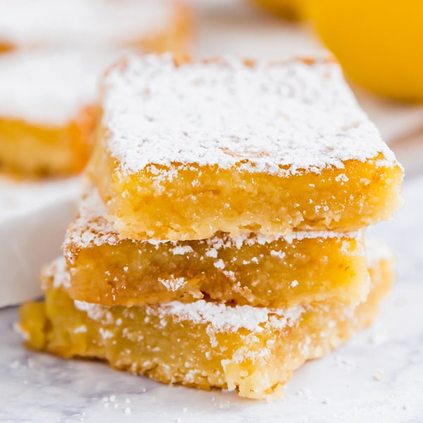 This Lemon Bars Recipe is a classic family favorite- super easy to throw together with a bright and tangy-sweet lemon curd layer and short bread crust.
