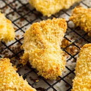 A close up image of fish sticks on a sheet pan.