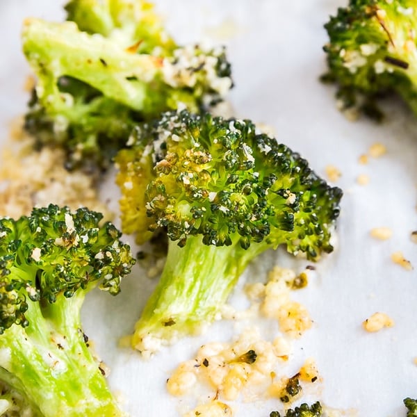 Garlic Parmesan Roasted Broccoli is a seriously easy side dish with a tasty kick of flavor. Just toss your broccoli florets with a few simple ingredients, pop them in the oven and you've go a deliciously addictive side dish!
