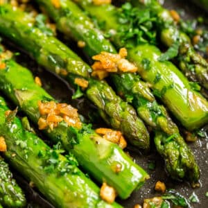 A close up photo of asparagus in a pan.