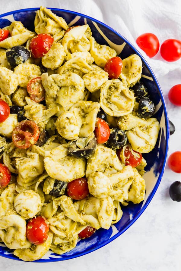 An overhead image of one side of a bowl of tortellini salad
