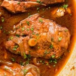 Wine Braised Chicken is the most mouthwatering, savory dinner you'll ever try! Slow simmered in red wine, this fall-apart-tender chicken is an easy dinner recipe the whole family will love.