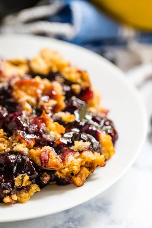 A close up image blueberry dump cake on a plate.