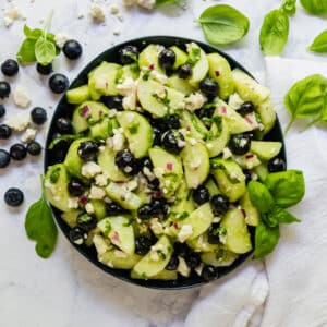Ready for a picnic side dish that isn't the same old salad selection we've all seen? This Blueberry Cucumber Salad recipe with Feta Cheese and a white balsamic dressing is light and refreshing! You'll want to bring it to every family gathering this summer!